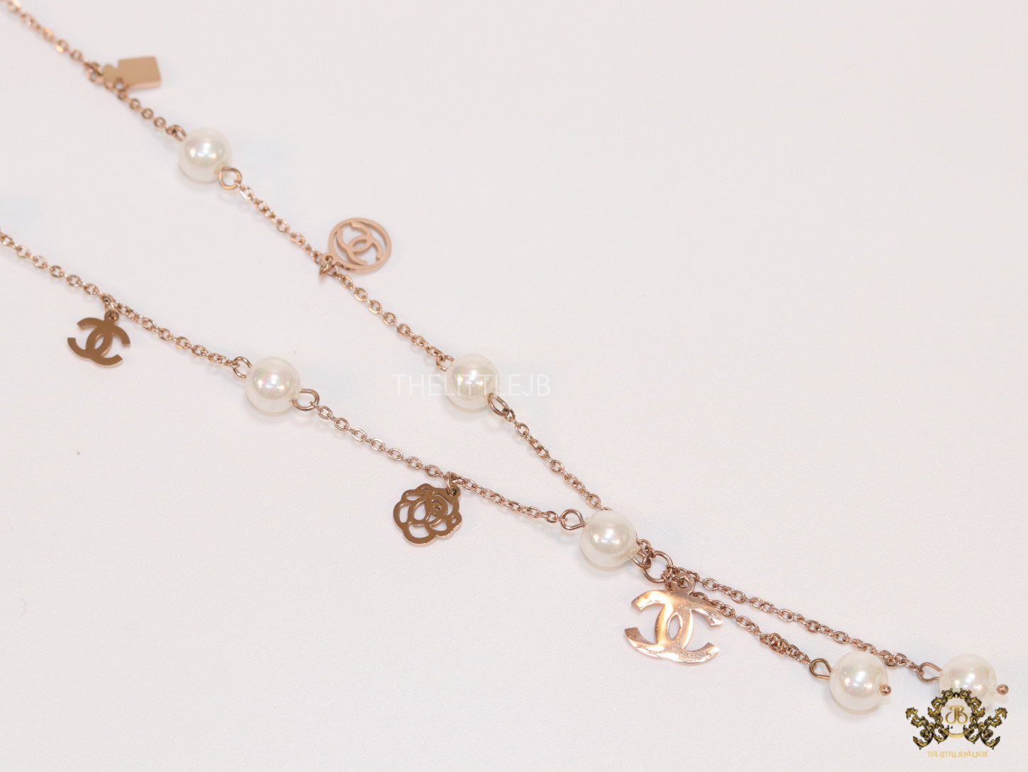 Gold chain necklace with pearls and alphabet motifs