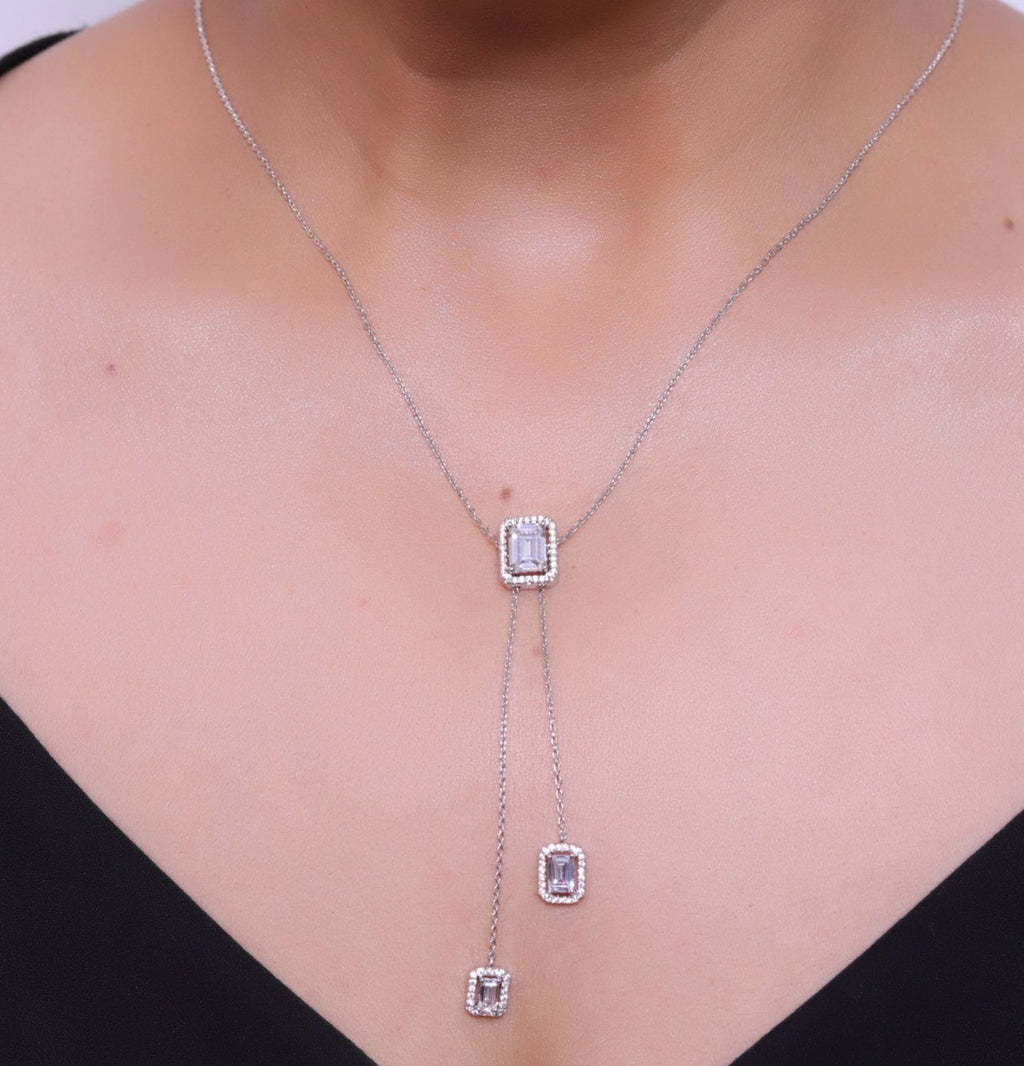 Emerald cut cubic zirconia stones in different sized on sleek platinum plated chain