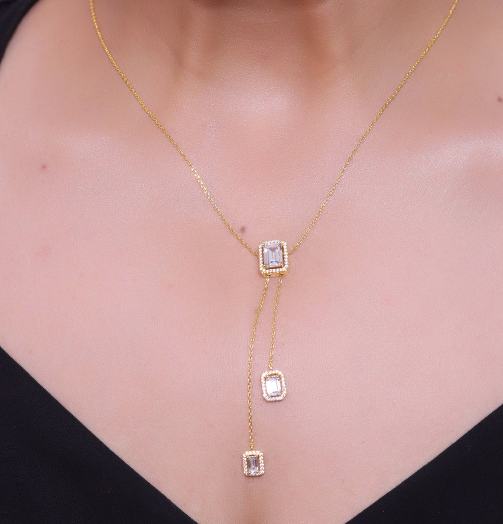 Emerald cut cubic zirconia stones in different sized on sleek gold plated chain