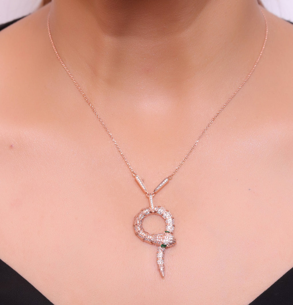Sleek rose gold plated chain with gold plated cubic zirconia ancient serpentine symbol pendant