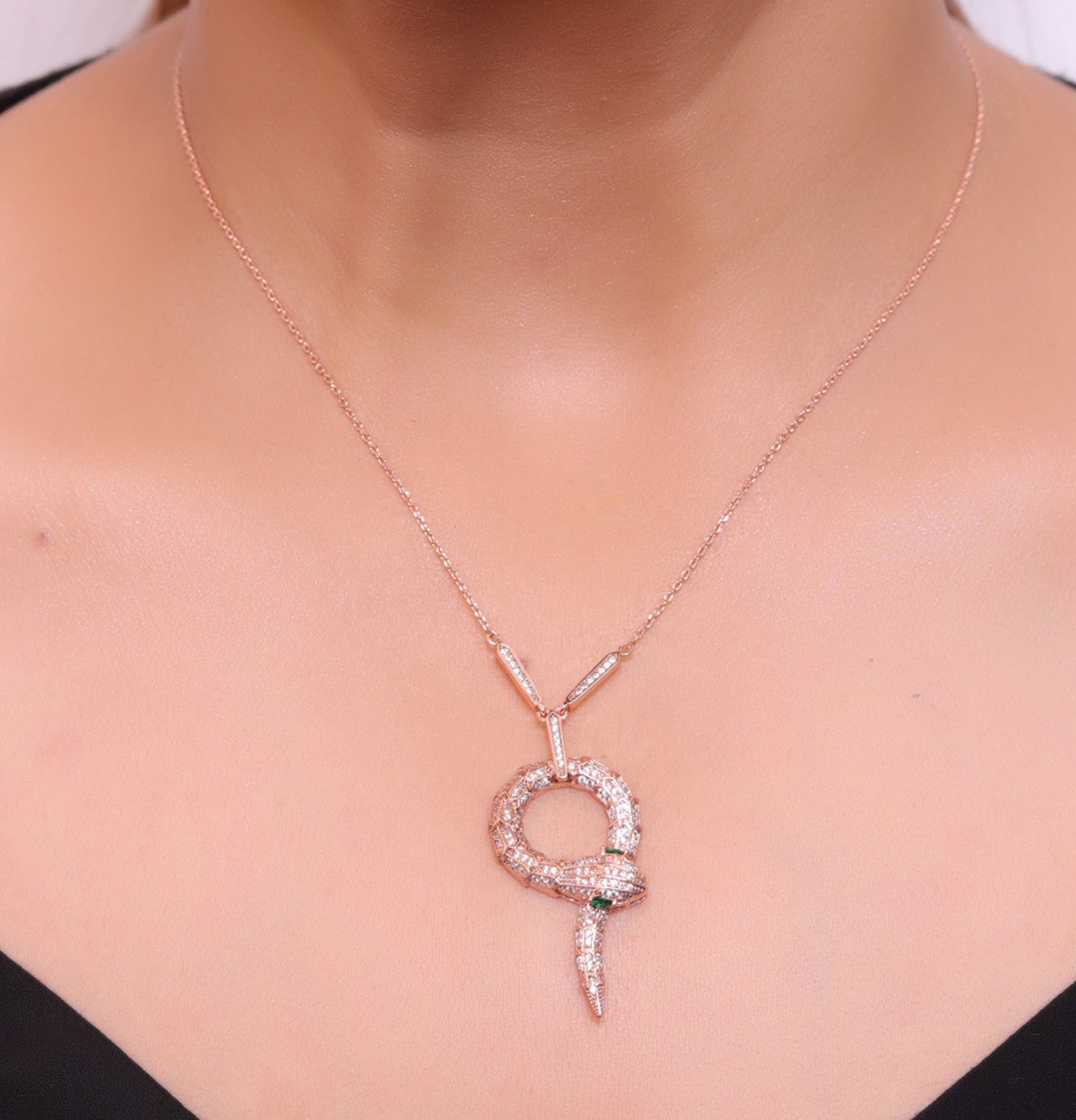 Sleek rose gold plated chain with gold plated cubic zirconia ancient serpentine symbol pendant