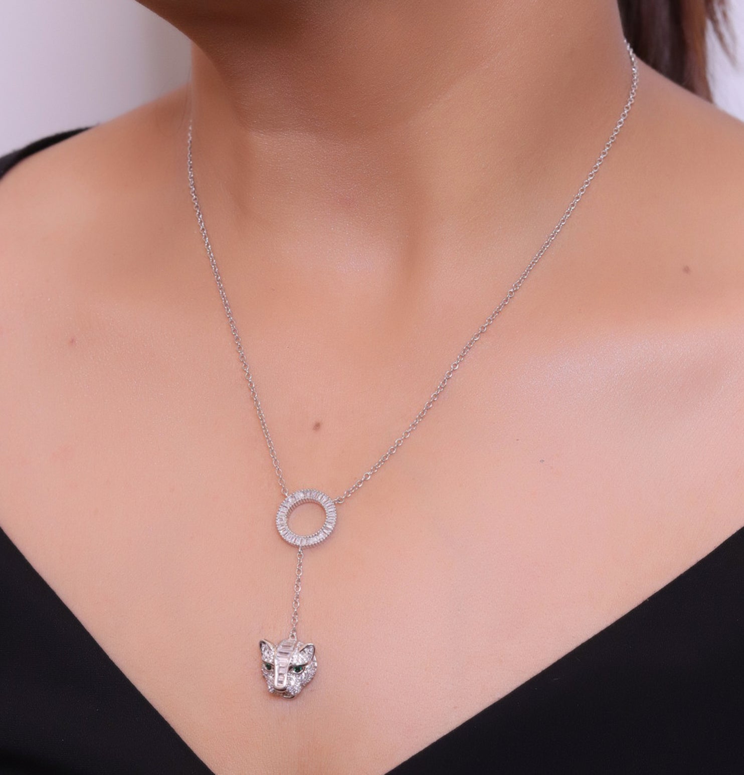 Platinum plated sleek chain with circular cubic zirconia disk and Platinum plated panther face motif pendant