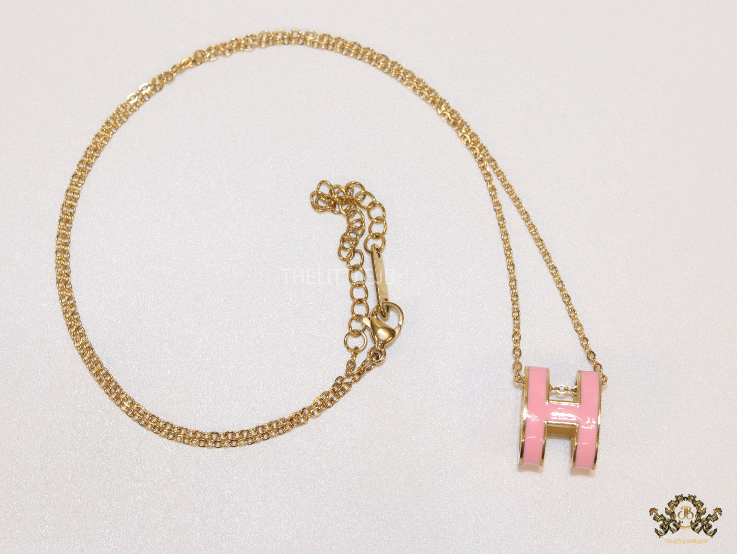 Gold chain necklace with pink enamel H motif