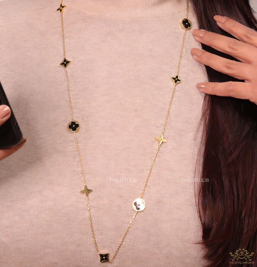 Golden chain necklace with black enamel clovers