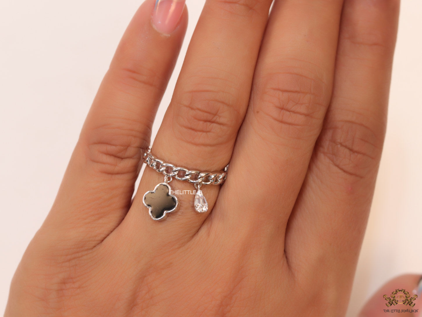 Platinum plated link chain ring with black clover and cz drop