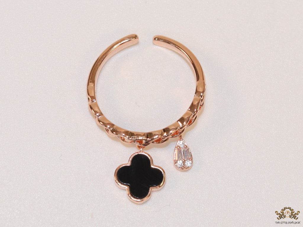 Rose gold plated link chain ring with black clover and cz drop