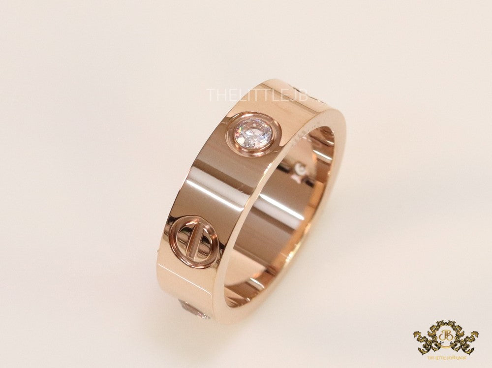 Broad 6mm rose gold band with screws and stones