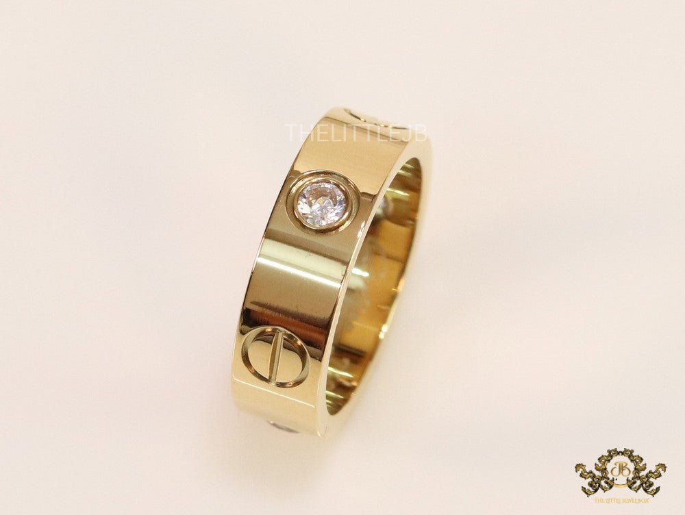 Broad 6mm gold plated band with screws and stones
