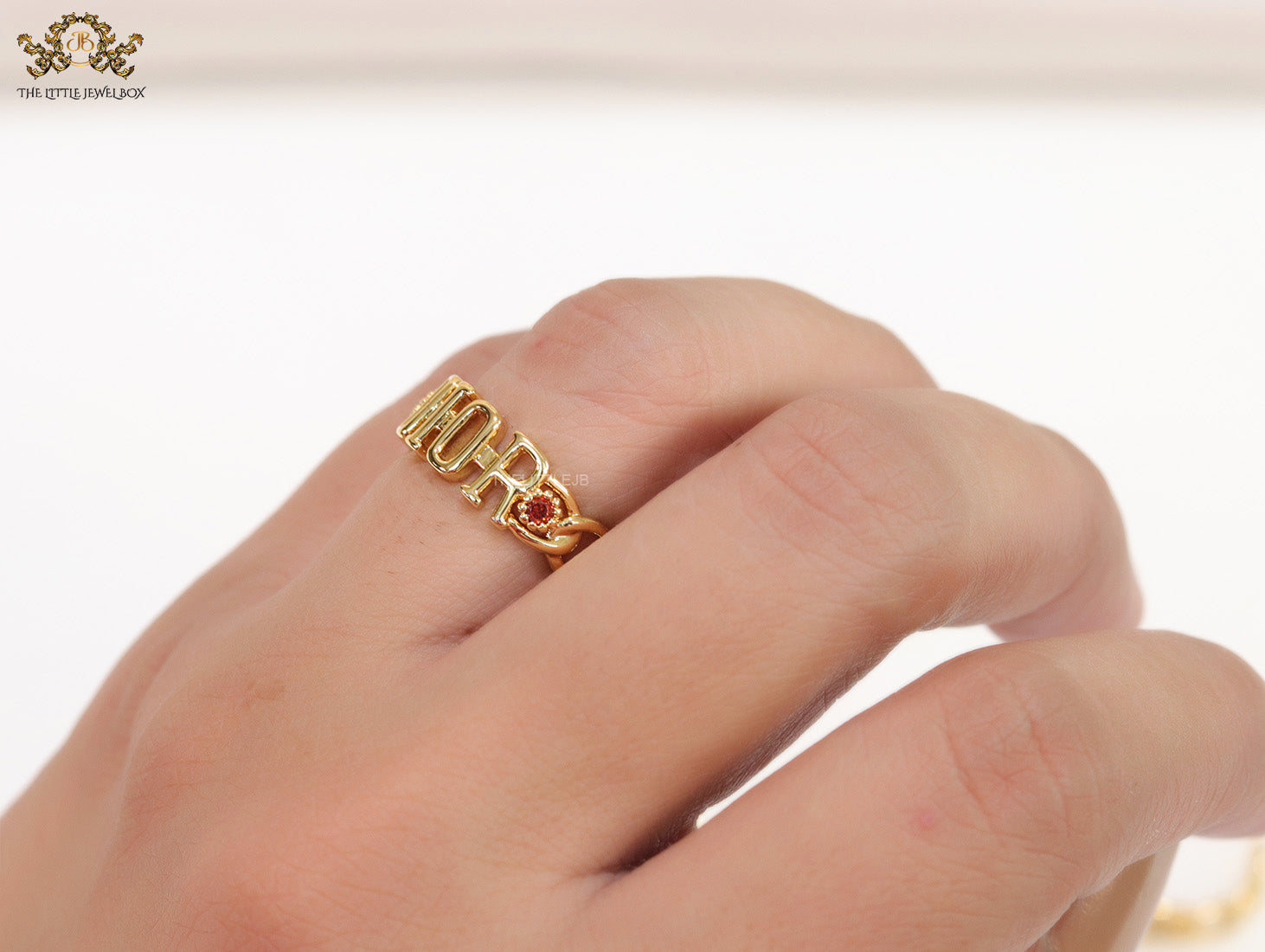 Gold plated alphabet open ring with orange cz