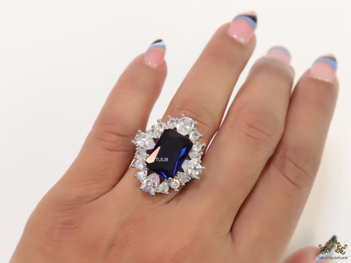 Adjustable sapphire blue cz ring in platinum finish
