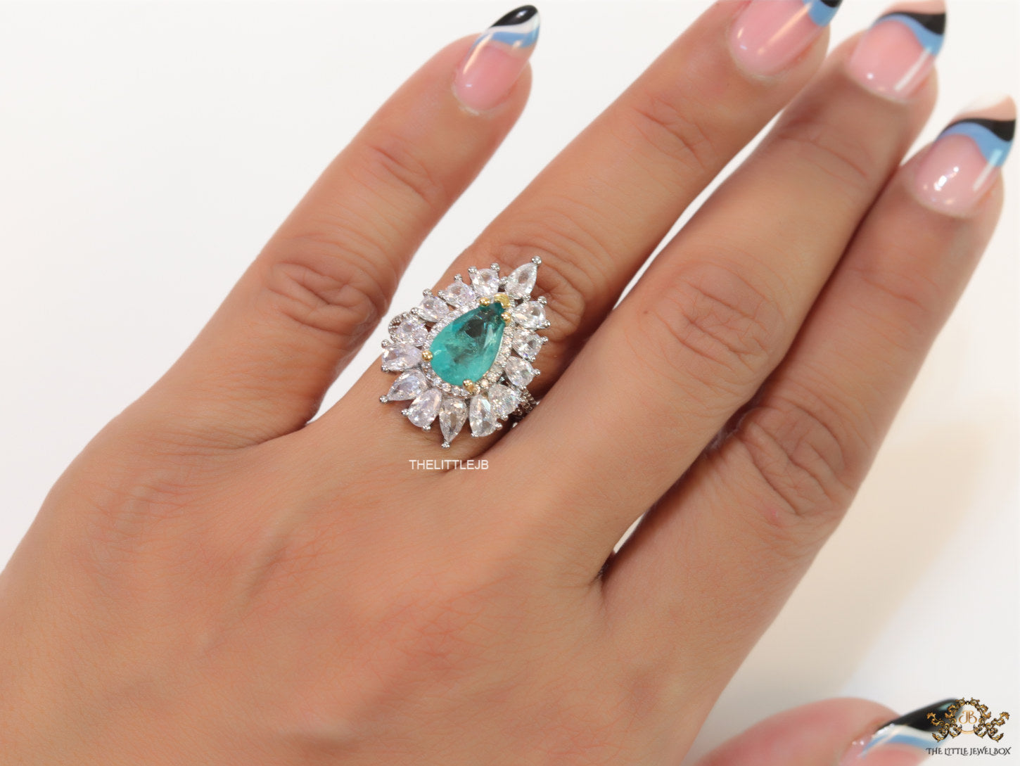 Adjustable drop shape fancy cz ring with green centre and platinum finish