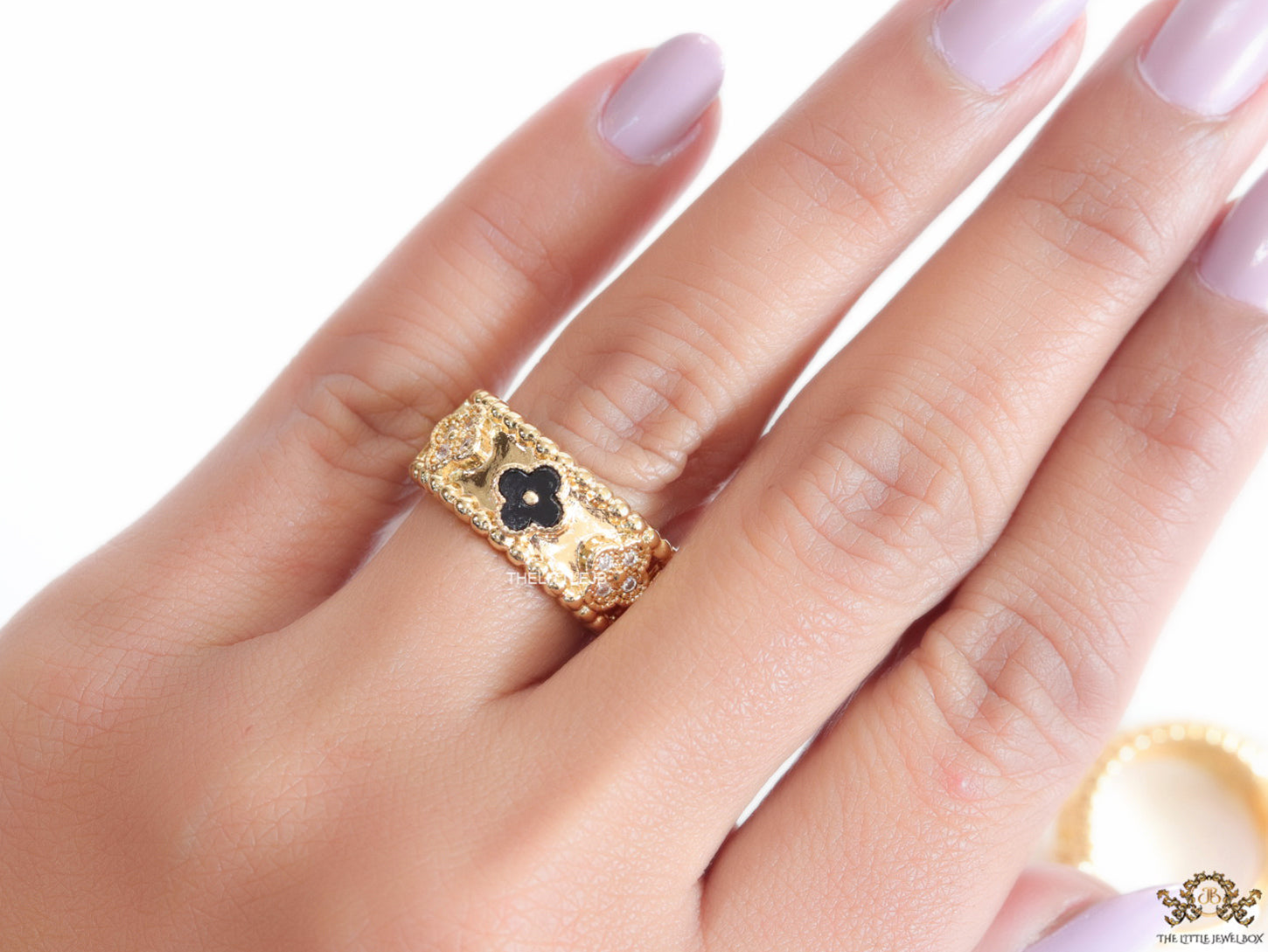 Golden ring band with black enamel and cz clovers
